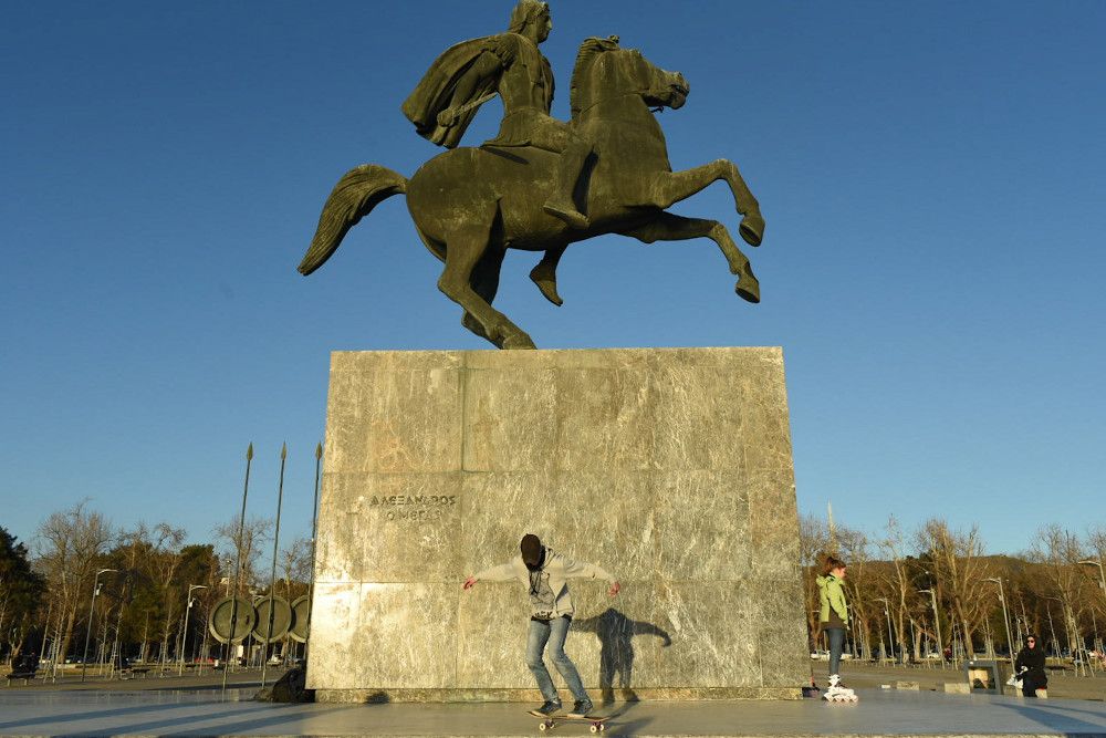 Un skateoarder devant la statue d'Alexandre le Grand sur son cheval à Thessalonique